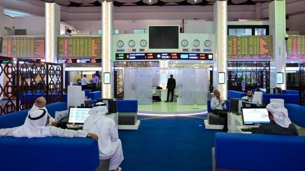 Traders follow financial markets at the Dubai Stock Exchange in the United Arab Emirates, on March 8, 2020. (AFP)