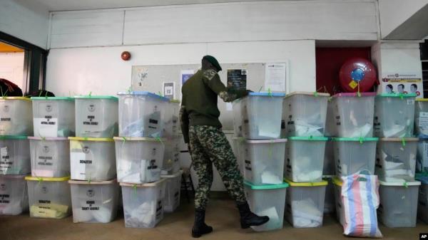 A member of security forces stands near ballot boxes stored at a collection and tallying center in Nairobi, Kenya Wednesday, Aug. 10, 2022. Kenyans are waiting for the results of a close but calm presidential election in which the turnout was lower than u
